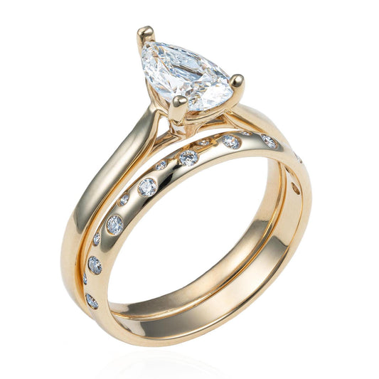 Pear Shaped Solitaire Diamond Wedding Set with Scattered Diamond Gypsy Band in 14K Yellow Gold